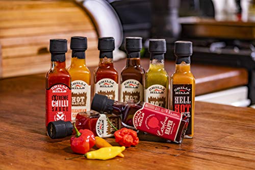 Chilli Hills salsa picante artesanal RED HEAT. Hecha con chiles NAGA INDIO y HABANERO ROJO, cultivados en nuestro huerto familiar. 100 % natural, sin OMG ni gluten, vegano. Botellita - 100 ml